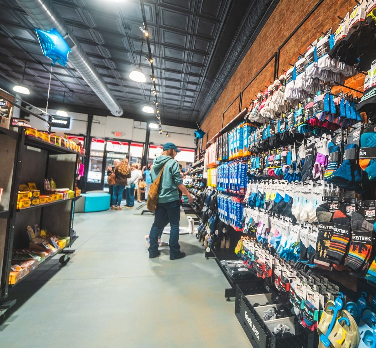 Store aisle stocked with socks, nutrition, and accessories